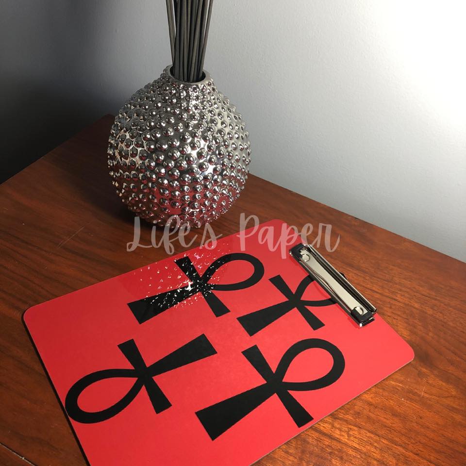 red background with black ankh image, double sided, 9x12 clipboard