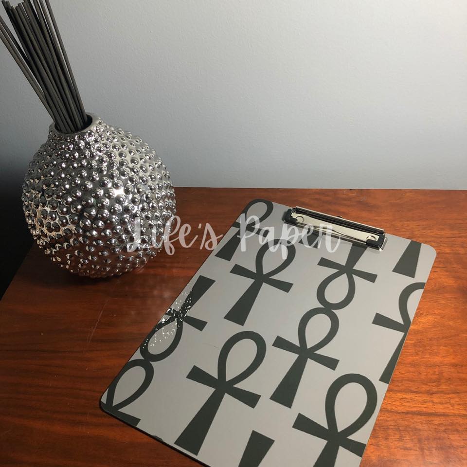 grey background with black ankh pattern image, double sided, 9x12 clipboard